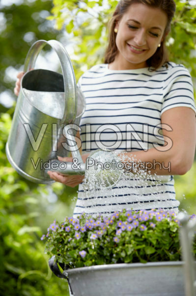 Lady watering plants Lady watering plants