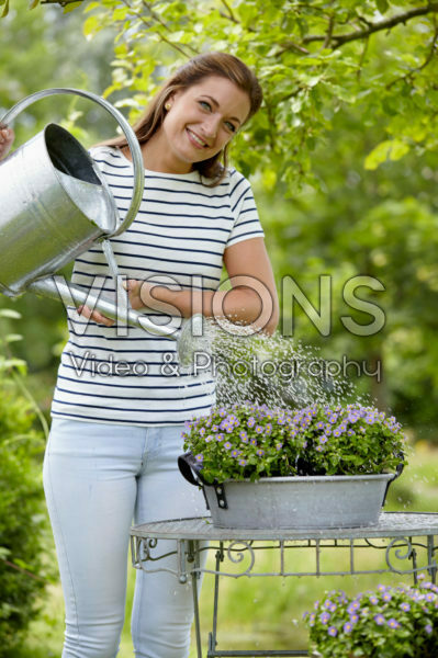 Lady watering plants Lady watering plants