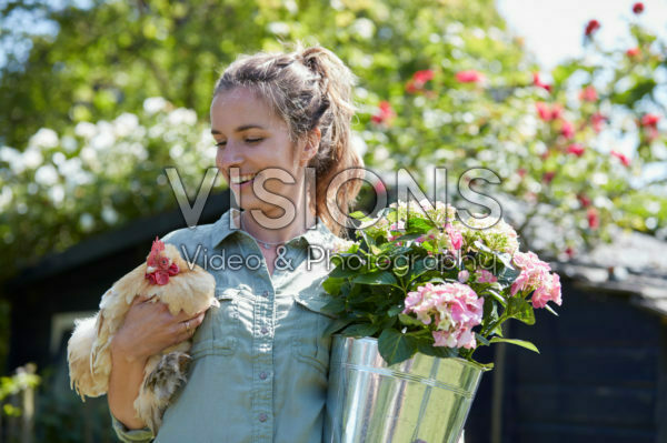 Lady holding hydrangea and chicken Lady holding hydrangea and chicken