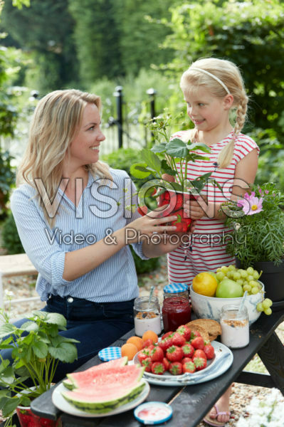 Mother and daughter with strawberries Mother and daughter with strawberries